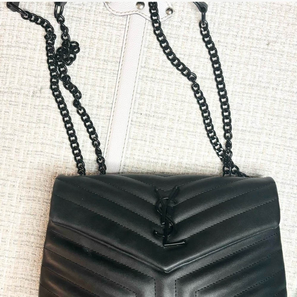 Black quilted leather bag with straps